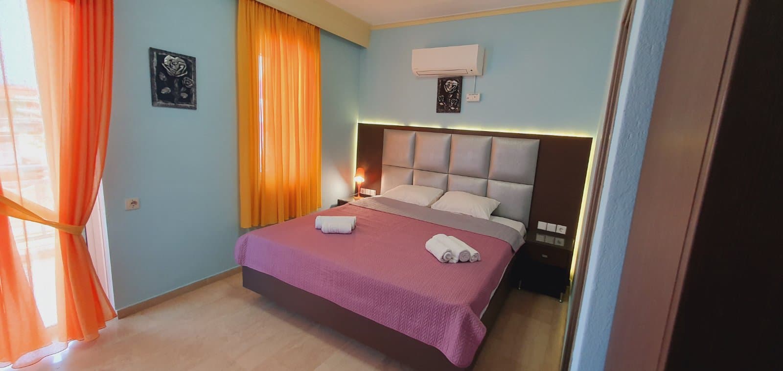 Room with towels folded at the end of the bed