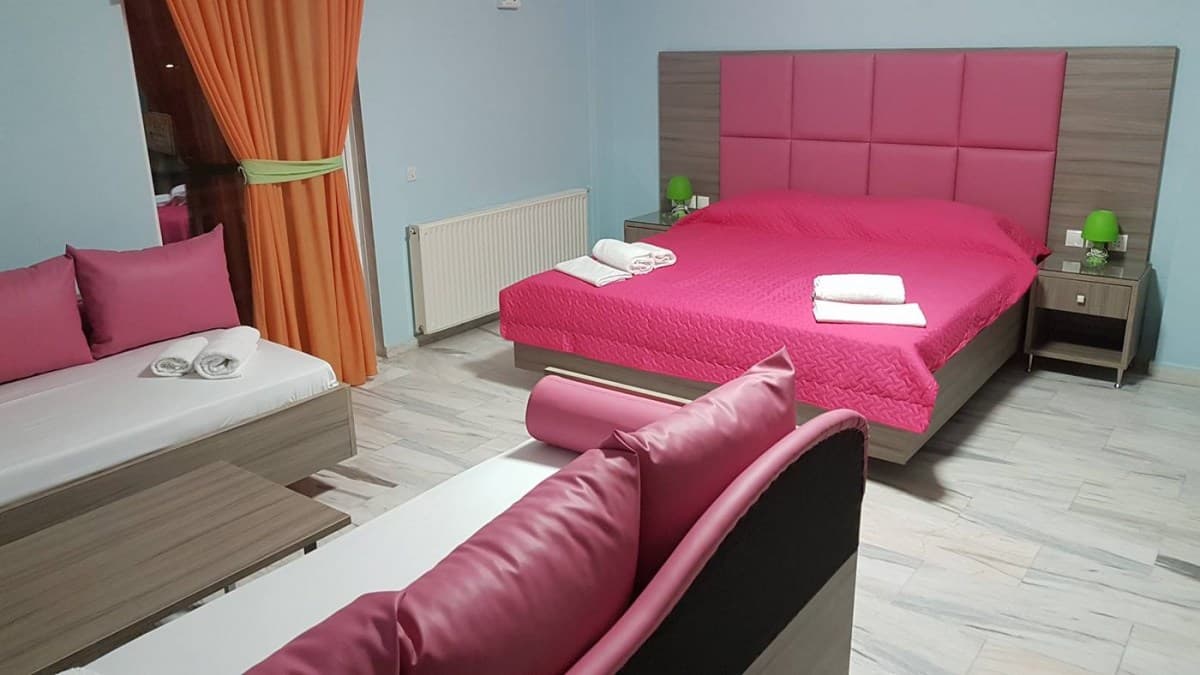 The quadruple room, with four single beds and a sofa