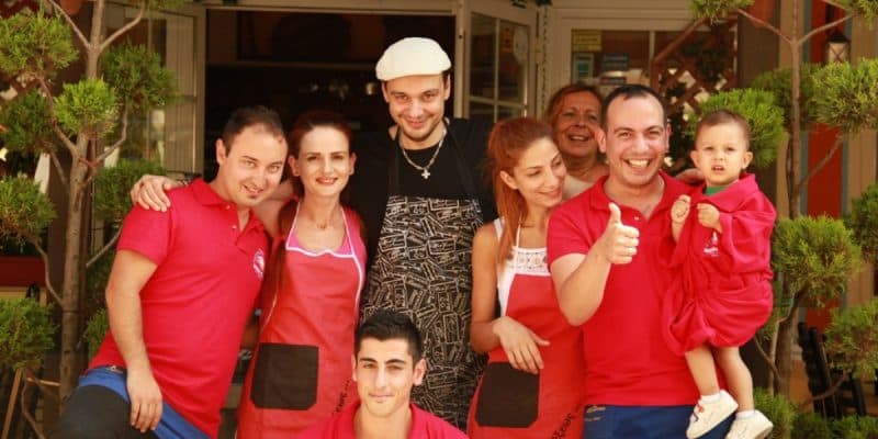 The family and staff outside the restaurant